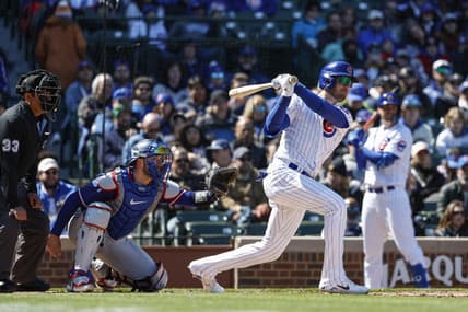 Apr 7, 2023; Chicago, Illinois, USA; Chicago Cubs center fielder Cody Bellinger (24) hits an RBI-single against the Texas Rangers during the fourth inning at Wrigley Field. Mandatory Credit: Kamil Krzaczynski-USA TODAY Sports