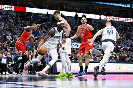 Apr 7, 2023; Dallas, Texas, USA; Dallas Mavericks forward Justin Holiday (0) grabs a rebound against the Chicago Bulls during the first quarter at the American Airlines Center. Mandatory Credit: Jerome Miron-USA TODAY Sports
