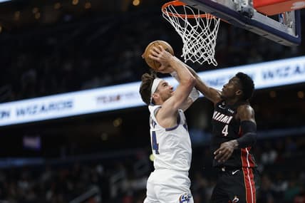 Apr 7, 2023; Washington, District of Columbia, USA; Washington Wizards forward Corey Kispert (24) is fouled while shooting the ball by Miami Heat guard Victor Oladipo (4) in the fourth quarter at Capital One Arena. Mandatory Credit: Geoff Burke-USA TODAY Sports