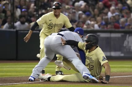 Apr 7, 2023; Phoenix, Arizona, USA; Arizona Diamondbacks left fielder Lourdes Gurriel Jr. (12) slides into Los Angeles Dodgers third baseman Max Muncy (13) safely in the third inning at Chase Field. Mandatory Credit: Rick Scuteri-USA TODAY Sports
