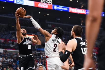 Apr 8, 2023; Los Angeles, California, USA; LA Clippers guard Eric Gordon (10) grabs a rebound against Portland Trail Blazers forward Trendon Watford (2) during the first quarter at Crypto.com Arena. Mandatory Credit: Jonathan Hui-USA TODAY Sports