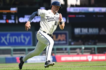 Apr 8, 2023; Minneapolis, Minnesota, USA; Minnesota Twins third baseman Kyle Farmer (12) scores on a single by catcher Christian Vazquez (not pictured) during the sixth inning against the Houston Astros at Target Field. Mandatory Credit: Jeffrey Becker-USA TODAY Sports