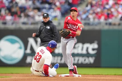 Apr 8, 2023; Philadelphia, Pennsylvania, USA; Cincinnati Reds shortstop Kevin Newman (28) turns a double play over Philadelphia Phillies third baseman Edmundo Sosa (33) during the fifth inning at Citizens Bank Park. Mandatory Credit: Gregory Fisher-USA TODAY Sports