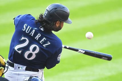 Apr 8, 2023; Cleveland, Ohio, USA; Seattle Mariners third baseman Eugenio Suarez (28) hits an RBI single in the first inning against the Cleveland Guardians at Progressive Field. Mandatory Credit: David Richard-USA TODAY Sports