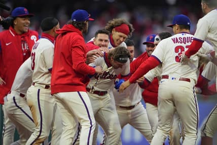 Apr 8, 2023; Philadelphia, Pennsylvania, USA; Philadelphia Phillies second baseman Bryson Stott (5) is mobbed by his teammates to congratulate him for getting the winning hit in the ninth inning against the Cincinnati Reds at Citizens Bank Park. Mandatory Credit: Gregory Fisher-USA TODAY Sports