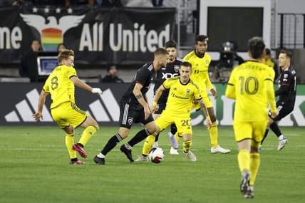 Apr 8, 2023; Washington, District of Columbia, USA; D.C. United midfielder Mateusz Klich (43) dribbles the ball against the Columbus Crew midfielder Aidan Morris (8) and Columbus Crew midfielder Alexandru Matan (20) at Audi Field. Mandatory Credit: Geoff Burke-USA TODAY Sports