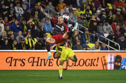 Apr 8, 2023; Nashville, Tennessee, USA; Toronto FC forward Federico Bernardeschi (10) and Nashville SC defender Daniel Lovitz (2) battle for a ball during the second half at Geodis Park. Mandatory Credit: Christopher Hanewinckel-USA TODAY Sports