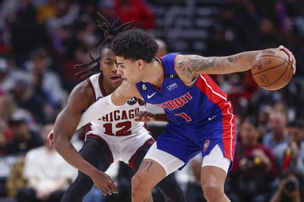 Apr 9, 2023; Chicago, Illinois, USA; Chicago Bulls guard Ayo Dosunmu (12) defends against Detroit Pistons guard Killian Hayes (7) during the first half at United Center. Mandatory Credit: Kamil Krzaczynski-USA TODAY Sports