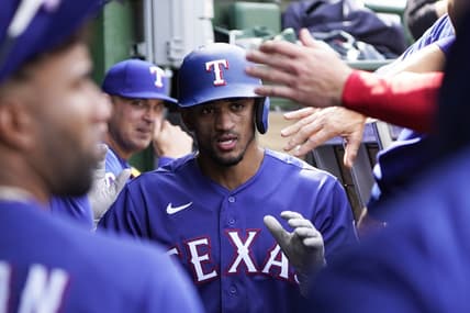 Apr 9, 2023; Chicago, Illinois, USA; Texas Rangers center fielder Bubba Thompson (8) is greeted in the dugout after scoring against the Chicago Cubs during the sixth inning at Wrigley Field. Mandatory Credit: David Banks-USA TODAY Sports