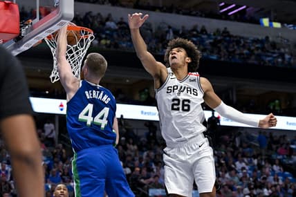 Apr 9, 2023; Dallas, Texas, USA; Dallas Mavericks forward Davis Bertans (44) dunks the ball past San Antonio Spurs forward Dominick Barlow (26) during the second quarter at the American Airlines Center. Mandatory Credit: Jerome Miron-USA TODAY Sports