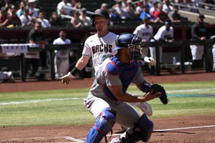Apr 9, 2023; Phoenix, Arizona, USA; Arizona Diamondbacks designated hitter Pavin Smith (26) beats a throw to Los Angeles Dodgers catcher Austin Barnes (15) to score a run during the first inning at Chase Field. Mandatory Credit: Joe Camporeale-USA TODAY Sports