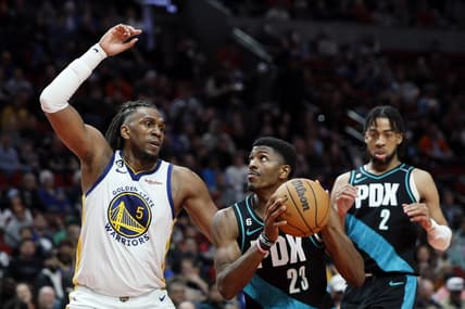 Apr 9, 2023; Portland, Oregon, USA; Portland Trail Blazers forward Jeenathan Williams (23) attempts to score as Golden State Warriors forward Kevon Looney (5) defends during the second half at Moda Center. Mandatory Credit: Soobum Im-USA TODAY Sports