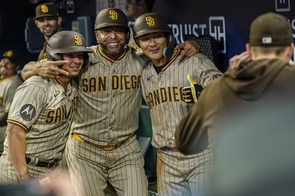 Apr 9, 2023; Cumberland, Georgia, USA; San Diego Padres second baseman Ha-Seong Kim (7) (right) gets a photo in the dugout with designated hitter Nelson Cruz (32) (center) and a bat boy after hitting a home run against the Atlanta Braves during the fifth inning at Truist Park. Mandatory Credit: Dale Zanine-USA TODAY Sports