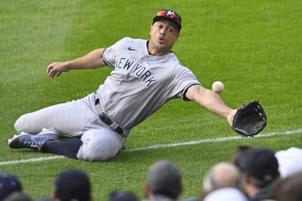 Apr 10, 2023; Cleveland, Ohio, USA; New York Yankees right fielder Giancarlo Stanton (27) reaches for a ball that landed foul in the second inning against the Cleveland Guardians at Progressive Field. Mandatory Credit: David Richard-USA TODAY Sports