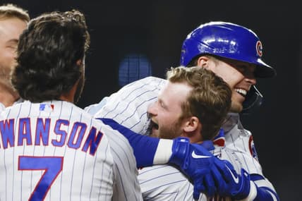 Apr 10, 2023; Chicago, Illinois, USA; Chicago Cubs second baseman Nico Hoerner (2) celebrates with teammates after hitting game winning single against the Seattle Mariners during the 10th inning at Wrigley Field. Mandatory Credit: Kamil Krzaczynski-USA TODAY Sports