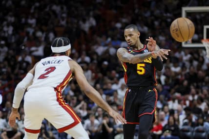 Apr 11, 2023; Miami, Florida, USA; Atlanta Hawks guard Dejounte Murray (5) passes the ball as Miami Heat guard Gabe Vincent (2) defends during the second quarter at Kaseya Center. Mandatory Credit: Sam Navarro-USA TODAY Sports