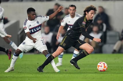 Apr 11, 2023; Los Angeles, CA, USA; LAFC midfielder Ilie Sanchez (6) and Vancouver Whitecaps forward Deiber Caicedo (7) battle for the ball in the first half at BMO Stadium. Mandatory Credit: Kirby Lee-USA TODAY Sports