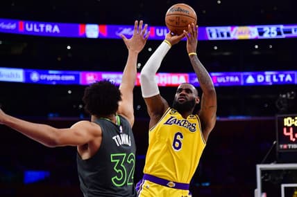 Apr 11, 2023; Los Angeles, California, USA; Los Angeles Lakers forward LeBron James (6) shoots against Minnesota Timberwolves center Karl-Anthony Towns (32) during the first half at Crypto.com Arena. Mandatory Credit: Gary A. Vasquez-USA TODAY Sports