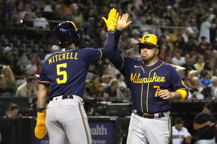 Apr 11, 2023; Phoenix, Arizona, USA; Milwaukee Brewers catcher Victor Caratini (7) celebrates with center fielder Garrett Mitchell (5) after scoring against the Arizona Diamondbacks in the seventh inning at Chase Field. Mandatory Credit: Rick Scuteri-USA TODAY Sports