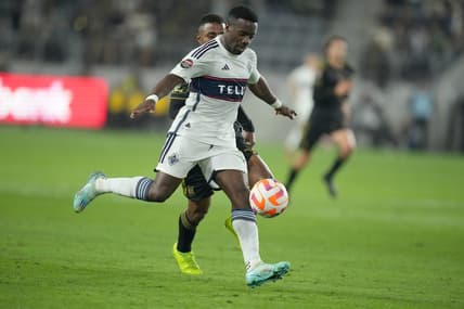 Apr 11, 2023; Los Angeles, CA, USA; Vancouver Whitecaps forward Cristian Dajome (11) and LAFC defender Diego Palacios (12) battle for the ball in the first half at BMO Stadium. Mandatory Credit: Kirby Lee-USA TODAY Sports