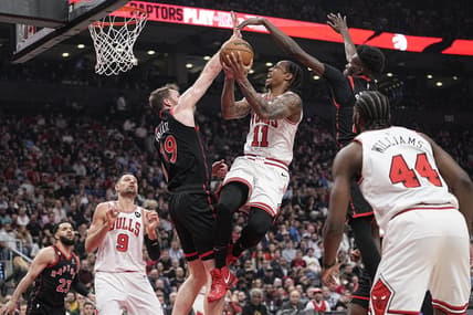 Apr 12, 2023; Toronto, Ontario, CAN; Toronto Raptors center Jakob Poeltl (19) and forward Chris Boucher (25) block a shot attempt by Chicago Bulls forward DeMar DeRozan (11) during the NBA Play-In game at Scotiabank Arena. Mandatory Credit: John E. Sokolowski-USA TODAY Sports