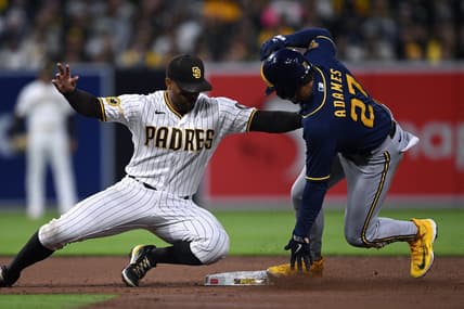 Apr 13, 2023; San Diego, California, USA; Milwaukee Brewers shortstop Willy Adames (27) steals second base ahead of the tag by San Diego Padres shortstop Xander Bogaerts (left) during the third inning at Petco Park. Mandatory Credit: Orlando Ramirez-USA TODAY Sports