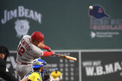 Apr 14, 2023; Boston, Massachusetts, USA; Los Angeles Angels right fielder Hunter Renfroe (12) hits an RBI double during the first inning against the Boston Red Sox at Fenway Park. Mandatory Credit: Bob DeChiara-USA TODAY Sports