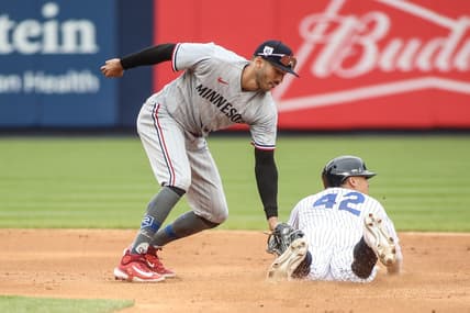 Apr 15, 2023; Bronx, New York, USA;  New York Yankees shortstop Anthony Volpe beats the tag of Minnesota Twins shortstop Carlos Correa for a stolen base in the fifth inning at Yankee Stadium. Mandatory Credit: Wendell Cruz-USA TODAY Sports
