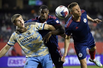 Apr 15, 2023; Chicago, Illinois, USA; Philadelphia Union forward Mikael Uhre (7) battles for a header against Chicago Fire defender Carlos Teran (4) and defender Arnaud Souquet (right) during the first half at Soldier Field. Mandatory Credit: Jon Durr-USA TODAY Sports