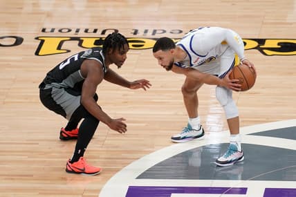 Apr 15, 2023; Sacramento, California, USA; Golden State Warriors guard Stephen Curry (30) holds onto the ball next to Sacramento Kings guard Davion Mitchell (15) in the second quarter during game one of the 2023 NBA playoffs at the Golden 1 Center. Mandatory Credit: Cary Edmondson-USA TODAY Sports