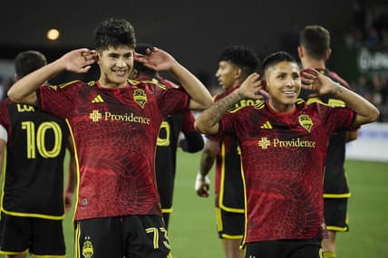 Apr 15, 2023; Portland, Oregon, USA; Seattle Sounders forward Raul Ruidiaz (9), right, celebrates scoring a goal with teammate midfielder Obed Vargas (73) during the second half against the Portland Timbers at Providence Park. Mandatory Credit: Troy Wayrynen-USA TODAY Sports