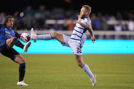 Apr 15, 2023; San Jose, California, USA; Sporting Kansas City forward Johnny Russell (7) reaches for the ball against San Jose Earthquakes forward Cade Cowell (left) during the first half at PayPal Park. Mandatory Credit: Darren Yamashita-USA TODAY Sports