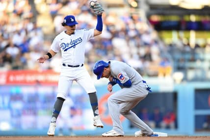 Apr 15, 2023; Los Angeles, California, USA; Chicago Cubs center fielder Cody Bellinger is safe at second base against Los Angeles Dodgers second baseman Miguel Vargas during the second inning at Dodger Stadium. Mandatory Credit: Jonathan Hui-USA TODAY Sports