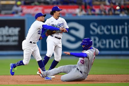 Apr 17, 2023; Los Angeles, California, USA; New York Mets first baseman Pete Alonso (20) is out at second as Los Angeles Dodgers shortstop Miguel Rojas (11) throws to first during the second inning at Dodger Stadium. Mandatory Credit: Gary A. Vasquez-USA TODAY Sports