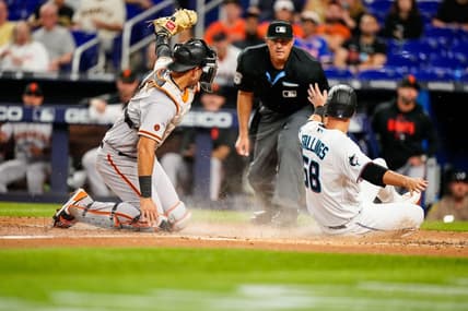 Apr 18, 2023; Miami, Florida, USA; San Francisco Giants catcher Blake Sabol (2) attempts to tag Miami Marlins catcher Jacob Stallings (58) as he slides into home base during the third inning at loanDepot Park. Mandatory Credit: Rich Storry-USA TODAY Sports