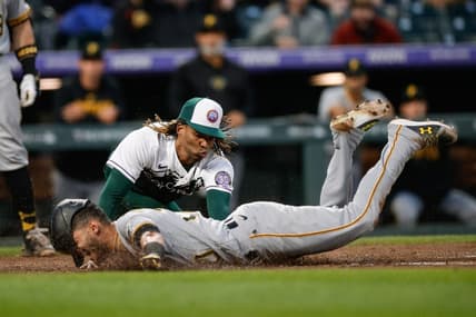Apr 18, 2023; Denver, Colorado, USA; Pittsburgh Pirates second baseman Tucupita Marcano (30) safely slides into home as Colorado Rockies starting pitcher Jose Urena (51) attempts to apply the tag after throwing a wild pitch in the fourth inning at Coors Field. Mandatory Credit: Isaiah J. Downing-USA TODAY Sports