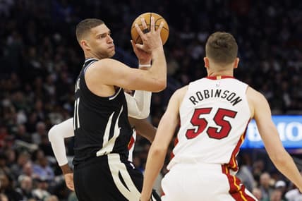 Apr 19, 2023; Milwaukee, Wisconsin, USA; Milwaukee Bucks center Brook Lopez (11) holds the ball away from Miami Heat guard Duncan Robinson (55) during the fourth quarter during game two of the 2023 NBA Playoffs at Fiserv Forum. Mandatory Credit: Jeff Hanisch-USA TODAY Sports
