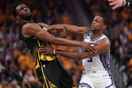 Apr 20, 2023; San Francisco, California, USA; Golden State Warriors forward Andrew Wiggins (22) is fouled by Sacramento Kings guard De'Aaron Fox (5) in the second quarter during game three of the 2023 NBA playoffs at the Chase Center. Mandatory Credit: Cary Edmondson-USA TODAY Sports