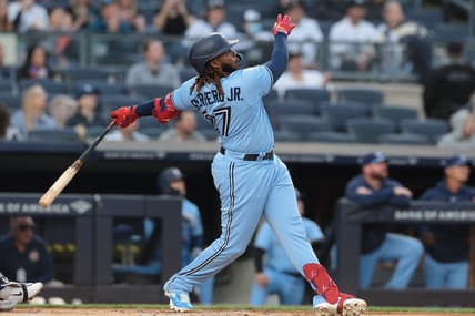 Apr 21, 2023; Bronx, New York, USA; Toronto Blue Jays first baseman Vladimir Guerrero Jr. (27) hits a two run home run during the first inning against the New York Yankees at Yankee Stadium. Mandatory Credit: Vincent Carchietta-USA TODAY Sports
