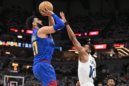 Apr 21, 2023; Minneapolis, Minnesota, USA; Denver Nuggets guard Jamal Murray (27) is defended by Minnesota Timberwolves guard Mike Conley (10) during the second quarter of game three of the 2023 NBA Playoffs at Target Center. Mandatory Credit: Jeffrey Becker-USA TODAY Sports