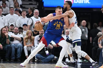 Apr 21, 2023; Minneapolis, Minnesota, USA; Denver Nuggets center Nikola Jokic (15) is defended by Minnesota Timberwolves center Rudy Gobert (27) during the fourth quarter of game three of the 2023 NBA Playoffs at Target Center. Mandatory Credit: Jeffrey Becker-USA TODAY Sports