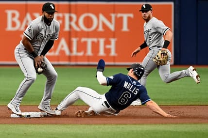 Apr 22, 2023; St. Petersburg, Florida, USA; Tampa Bay Rays third basemanTaylor Walls (0) slides as Chicago White Sox shortstop Elvis Andrus (1) catches the ball in the first inning at Tropicana Field. Mandatory Credit: Jonathan Dyer-USA TODAY Sports