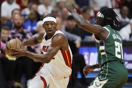 Apr 22, 2023; Miami, Florida, USA; Miami Heat forward Jimmy Butler (22) drives to the basket against Milwaukee Bucks guard Jrue Holiday (21) in the first quarter during game three of the 2023 NBA Playoffs at Kaseya Center. Mandatory Credit: Sam Navarro-USA TODAY Sports