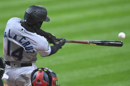 Apr 22, 2023; Cleveland, Ohio, USA; Miami Marlins left fielder Bryan De La Cruz (14) doubles against the Cleveland Guardians in the second inning at Progressive Field. Mandatory Credit: David Richard-USA TODAY Sports