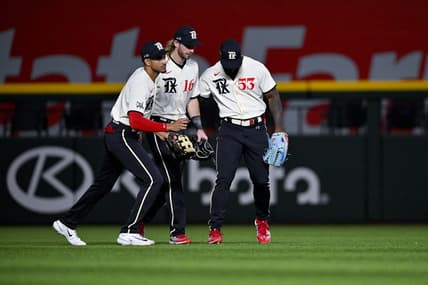 Apr 22, 2023; Arlington, Texas, USA; Texas Rangers left fielder Bubba Thompson (8) and left fielder Travis Jankowski (16) and right fielder Adolis Garcia (53) celebrate the Rangers victory over the Oakland Athletics at Globe Life Field. Mandatory Credit: Jerome Miron-USA TODAY Sports
