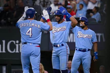 Apr 23, 2023; Arlington, Texas, USA; Texas Rangers designated hitter Robbie Grossman (4) and center fielder Leody Taveras (3) and second baseman Marcus Semien (2) celebrate after Grossman hits a three run home run against the Oakland Athletics during the second inning at Globe Life Field. Mandatory Credit: Jerome Miron-USA TODAY Sports