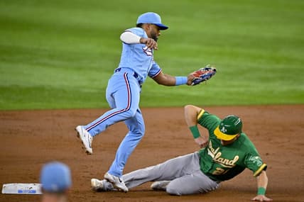 Apr 23, 2023; Arlington, Texas, USA; Oakland Athletics right fielder Conner Capel (21) slides under the tag of Texas Rangers shortstop Ezequiel Duran (20) during the second inning at Globe Life Field. Mandatory Credit: Jerome Miron-USA TODAY Sports