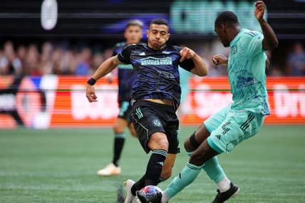 Apr 23, 2023; Atlanta, Georgia, USA; Atlanta United forward Giorgos Giakoumakis (7) battles for the ball against Chicago Fire defender Carlos Teran (4) during the first half at Mercedes-Benz Stadium. Mandatory Credit: Brett Davis-USA TODAY Sports
