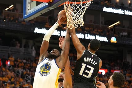 Apr 23, 2023; San Francisco, California, USA; Golden State Warriors forward Kevon Looney (5) reaches for a rebound against Sacramento Kings forward Keegan Murray (13) and forward Domantas Sabonis (lower center) during the third quarter of game four of the 2023 NBA playoffs at Chase Center. Mandatory Credit: Darren Yamashita-USA TODAY Sports