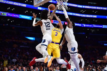 Apr 24, 2023; Los Angeles, California, USA; Los Angeles Lakers forward Anthony Davis (3) moves to the basket against Memphis Grizzlies guard Ja Morant (12) and forward Jaren Jackson Jr. (13) during the first half in game four of the 2023 NBA playoffs at Crypto.com Arena. Mandatory Credit: Gary A. Vasquez-USA TODAY Sports